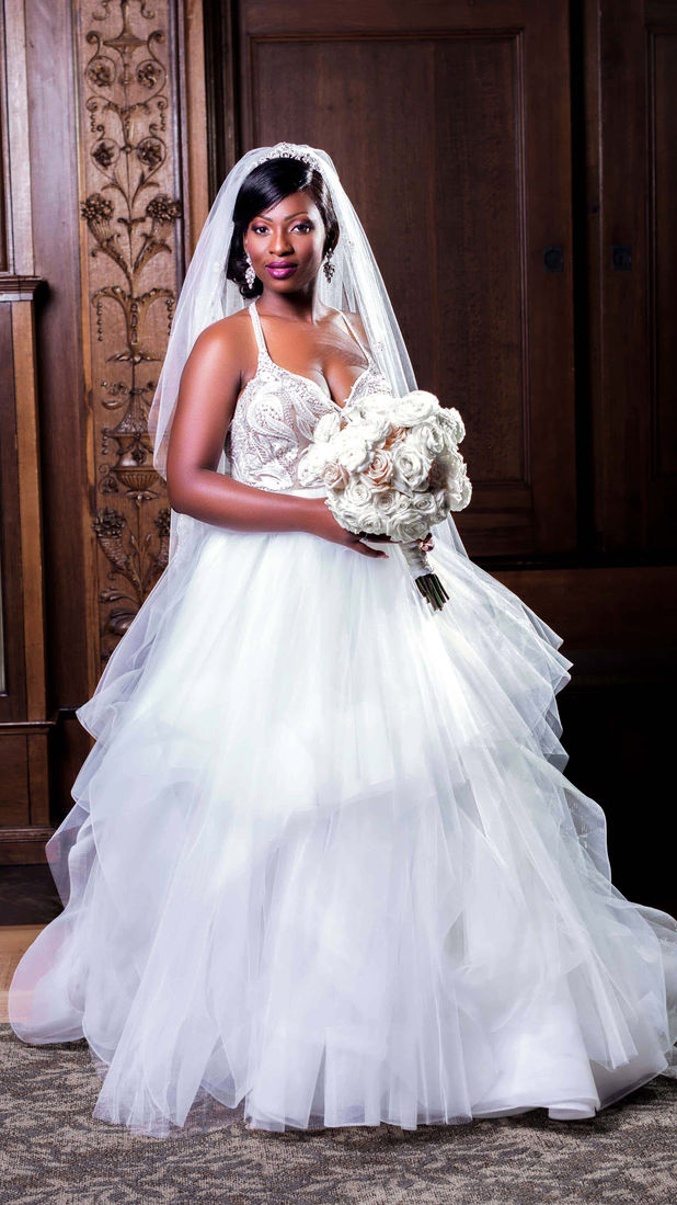 A bride in a white wedding dress, holding a bouquet smiling for a photo, radiating happiness on her special day.