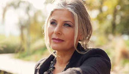 Mid-aged woman with thoughtful facial expression