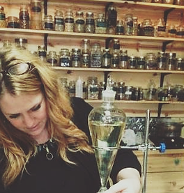 Carrie in front of all her remedies.png