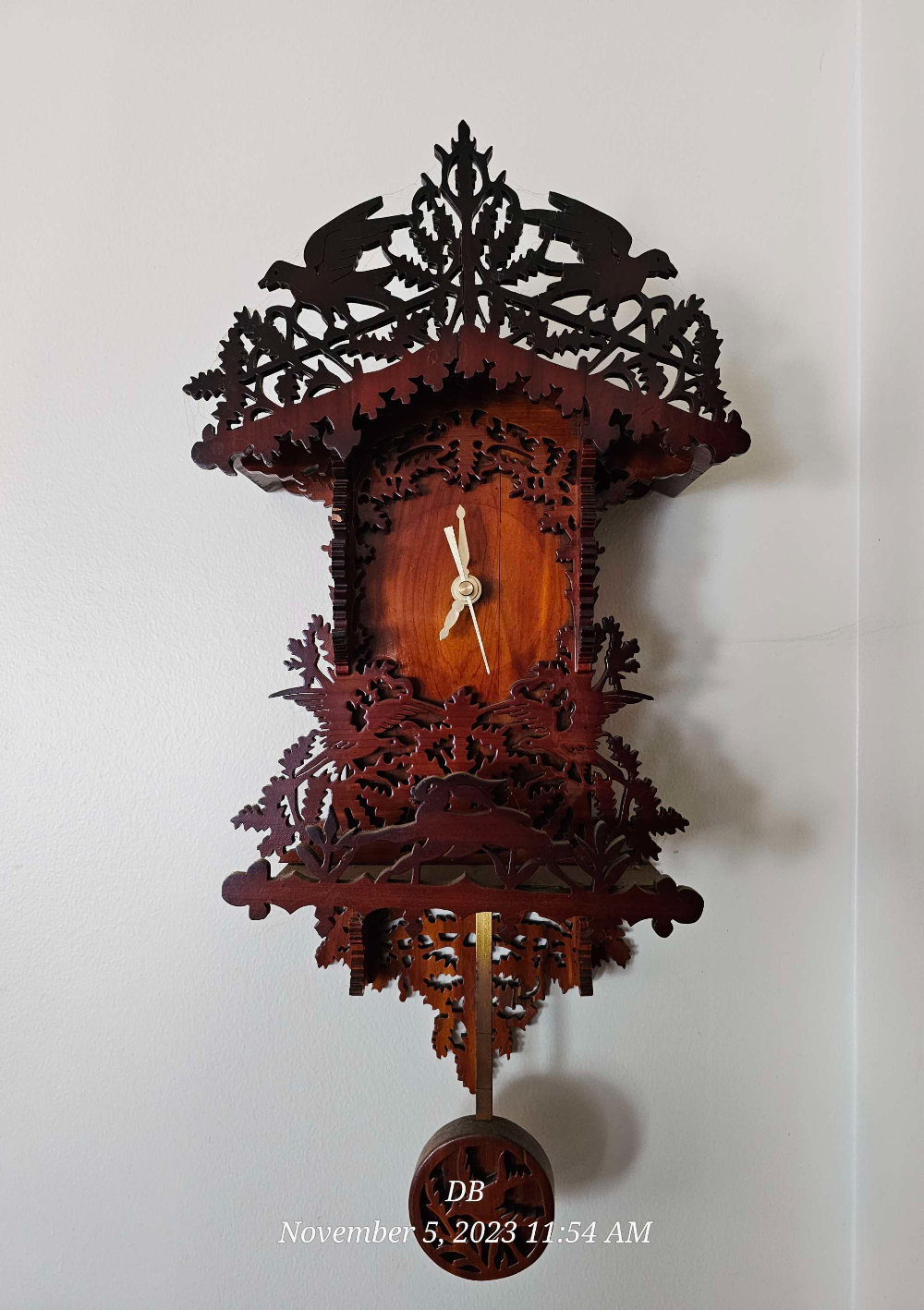 Restored carved wooden wall clock