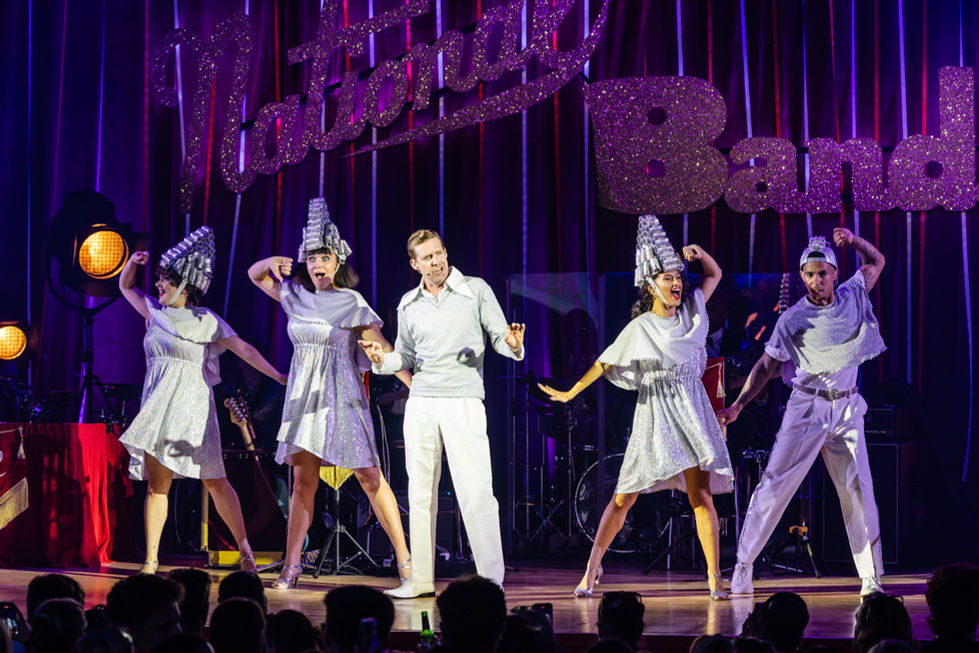 Ricky Wilson (c) (Teen Angel) and the cast from Grease The Immersive Movie Mousical - cred