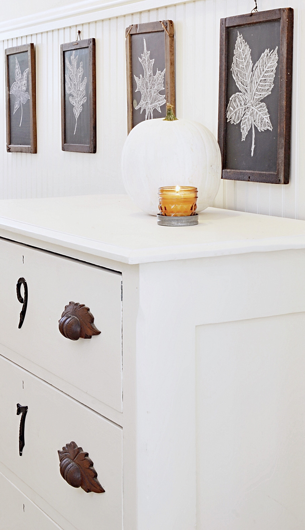 Antique children's slate in entryway with fall decor.