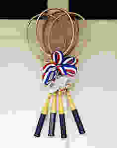 Vintage badminton racquets with vintage birdies and red, white and blue ribbon.