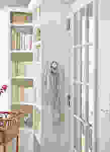 Porcelan white door knob wall hangers and bookshelves w/ books.