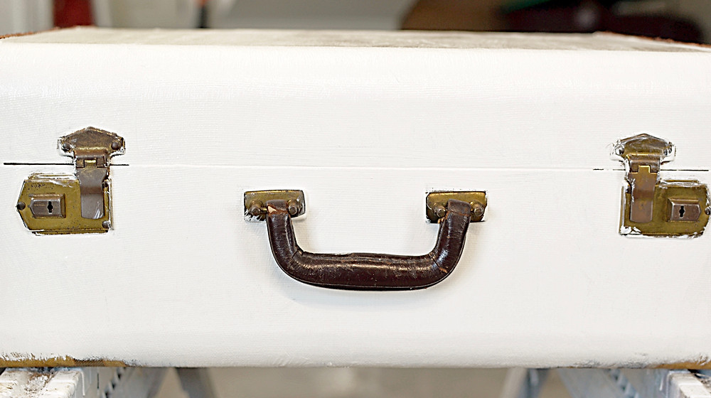 Vintage suitcase with two coats of antique white paint.