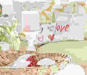 Valentine's Day decor with pillows, candles and heart basket.