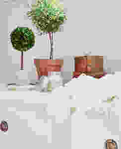 white dresser styled with toparies.