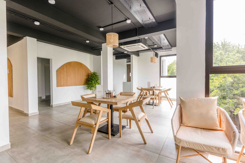 Modern dining area with wooden furniture and neutral tones.