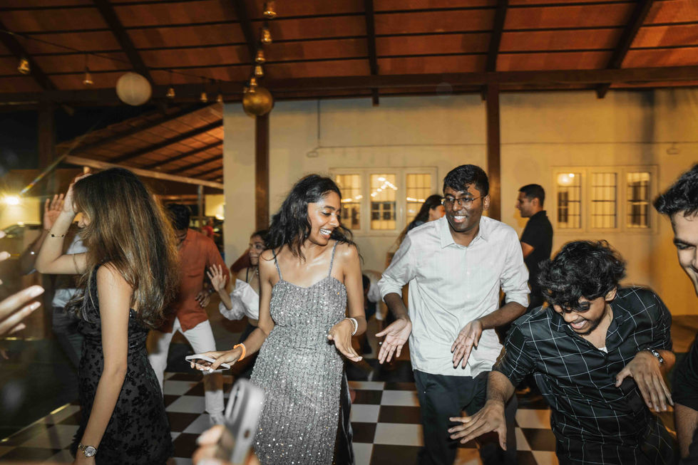 People dancing joyfully at a lively indoor event.