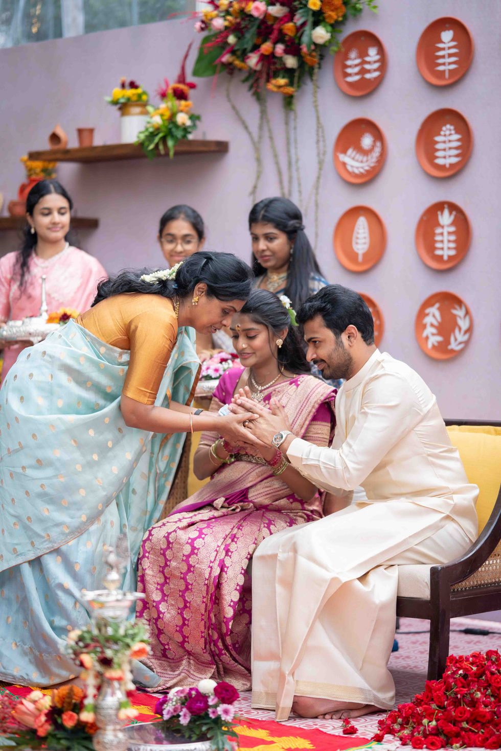 People celebrating a traditional ceremony with decorations.