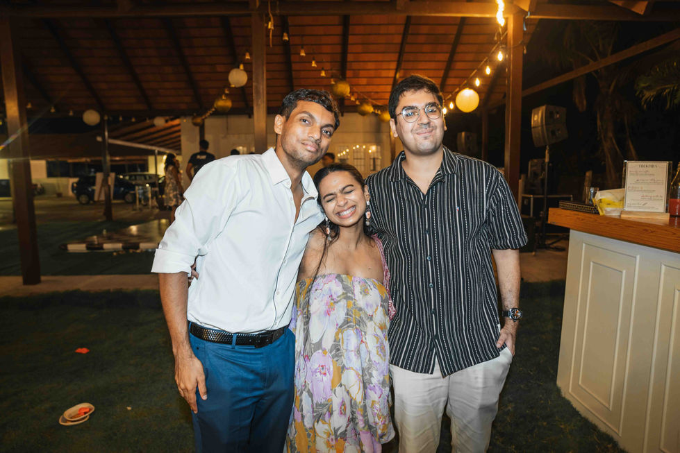 Three people smiling at an outdoor event.