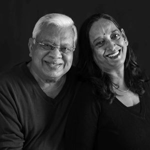 Smiling couple in black and white portrait.