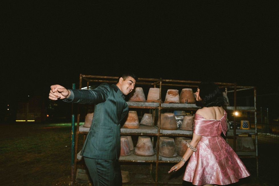 Bride and Groom dancing near stacked clay pots.