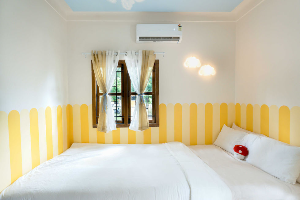 Bright bedroom with striped walls and large window.