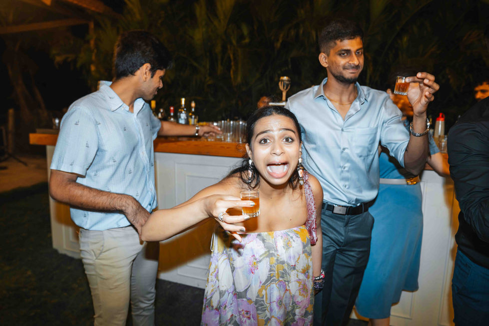 Three people enjoying a party with drinks.