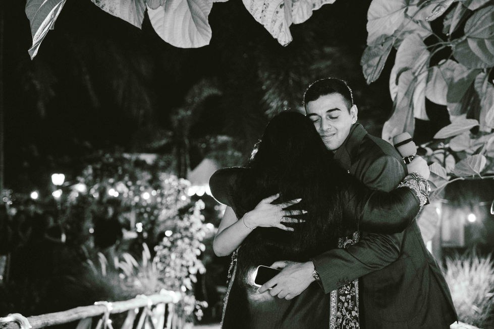 Two people hugging at an outdoor event.
