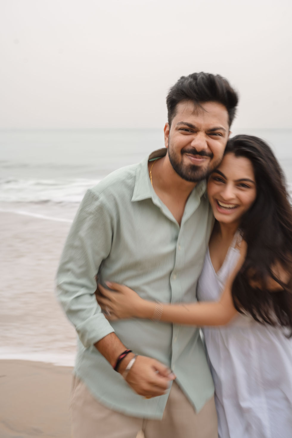 Couple posing for a photo at the beach.
