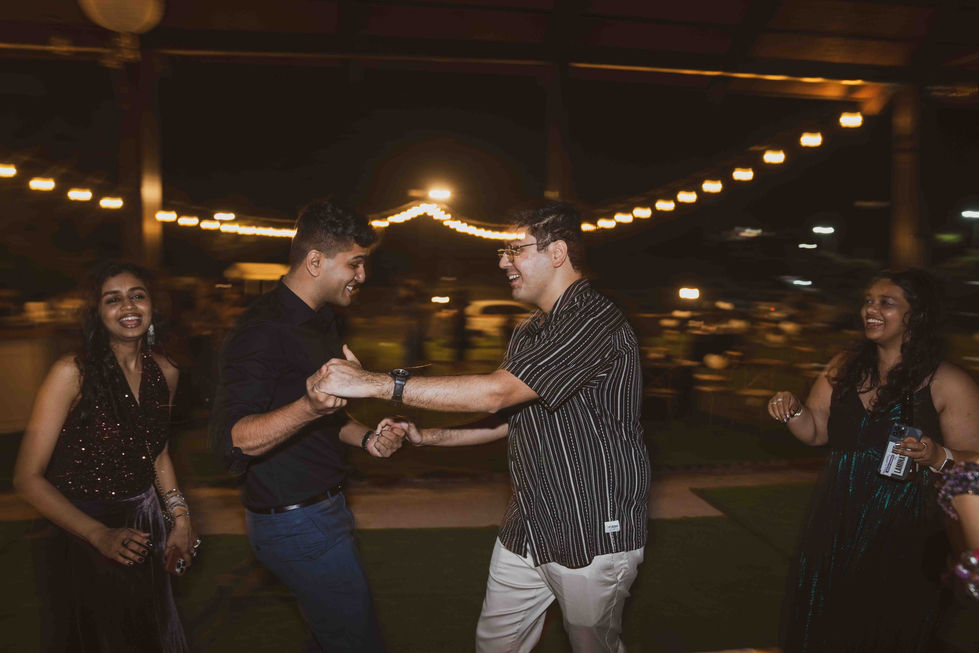 Two people dancing at an outdoor event.