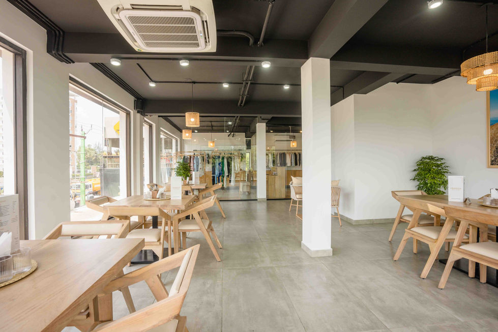 Modern cafe interior with wooden tables and chairs.