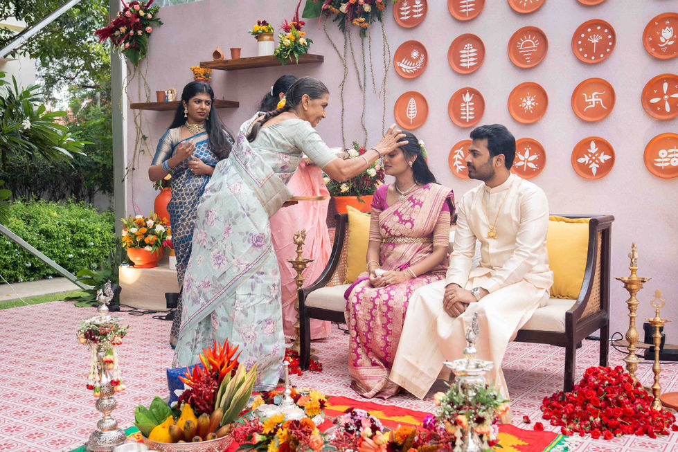 Traditional ceremony with people in festive attire and decorations.