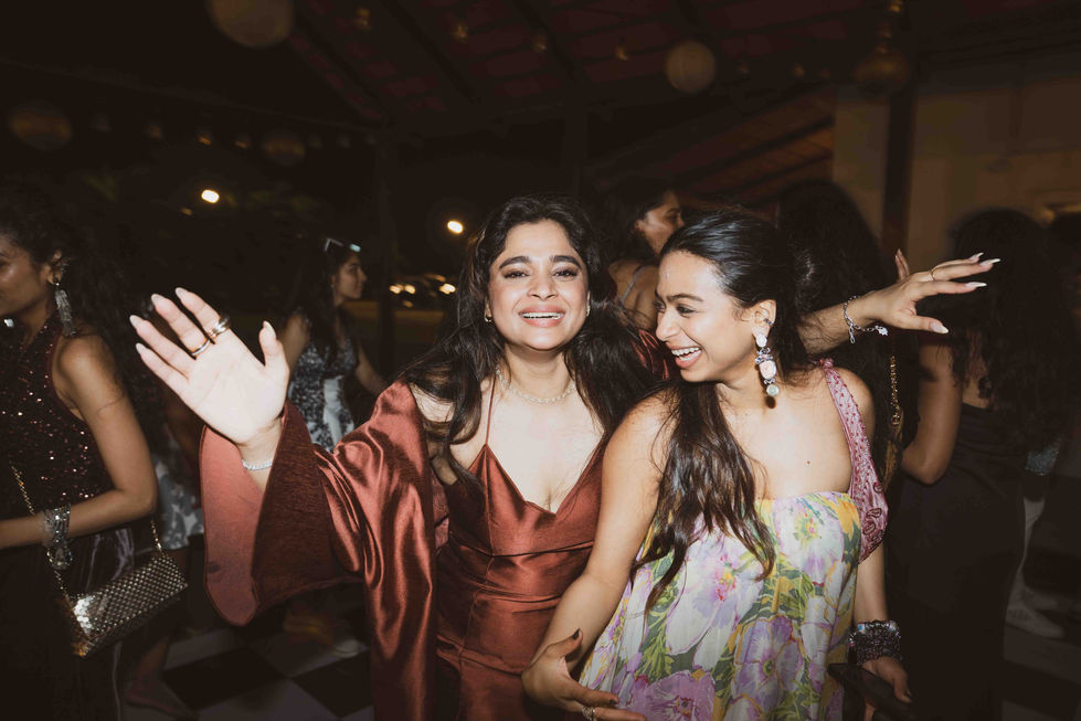 Two people joyfully dancing at an event.