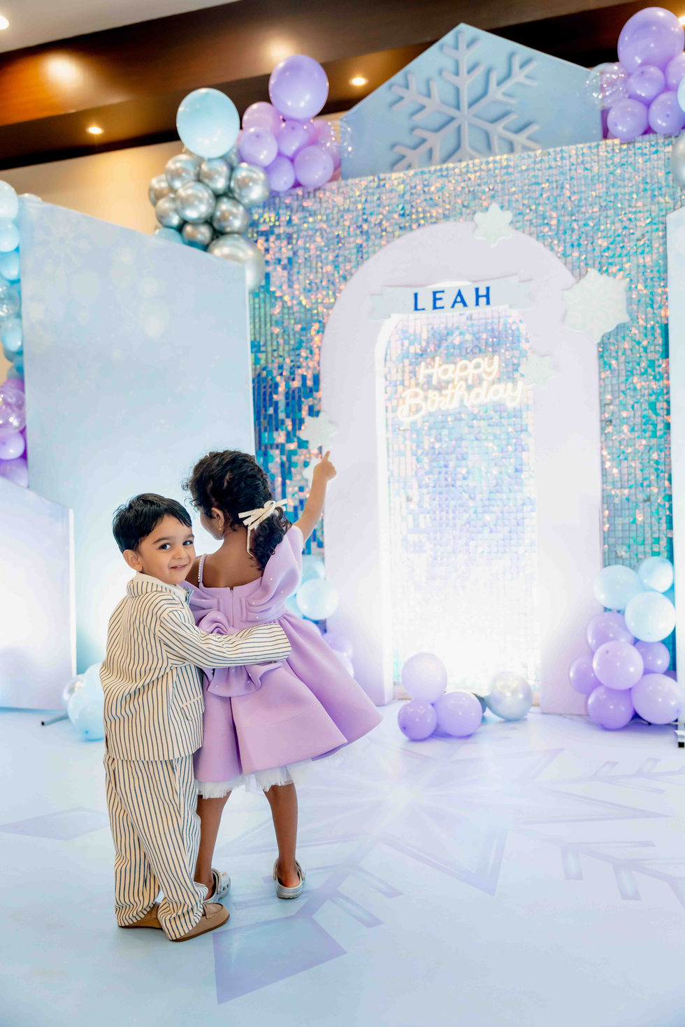 Children celebrating at a pastel-themed birthday party.