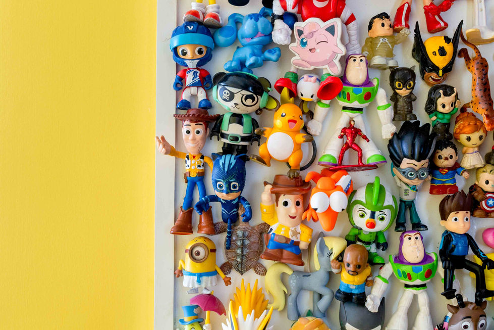 Assorted toy figures displayed on a yellow background.