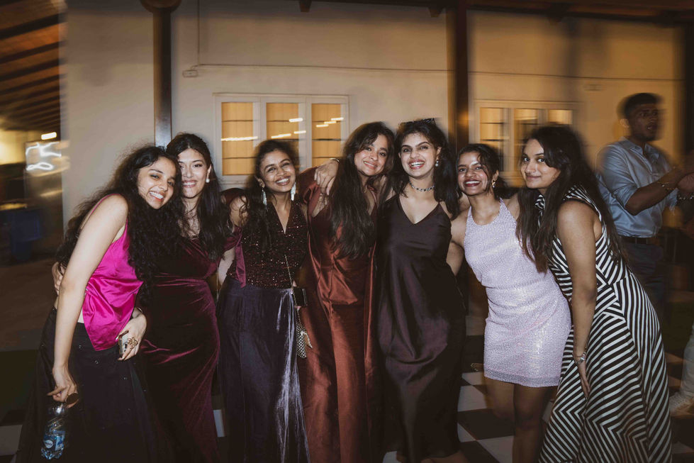 Seven people smiling, dressed in formal attire.
