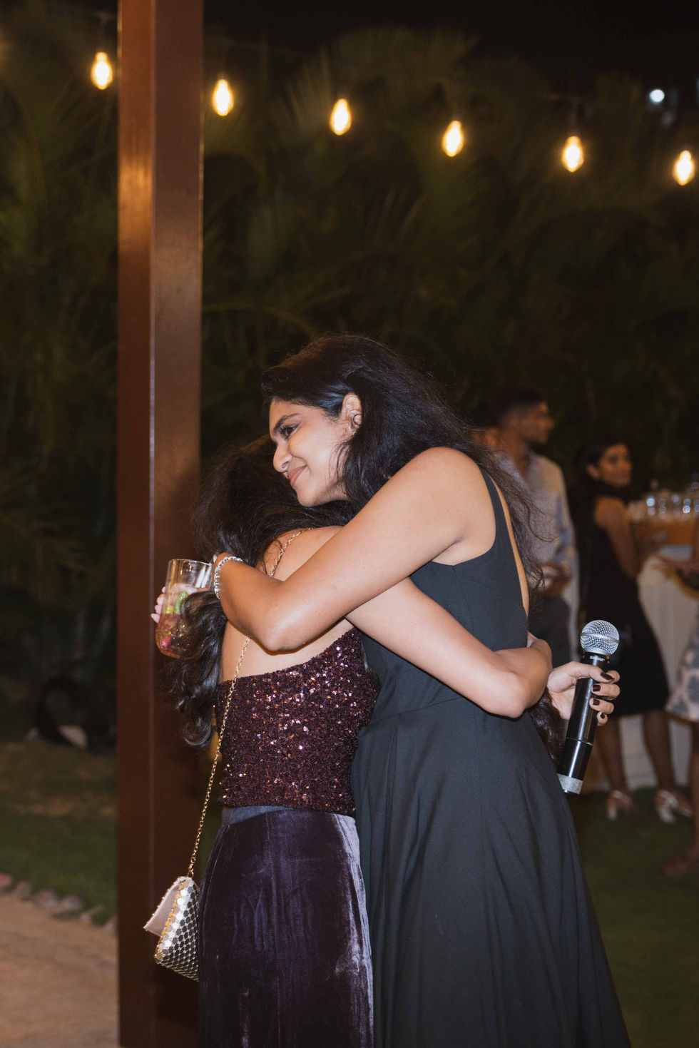 Two people hugging at an event.
