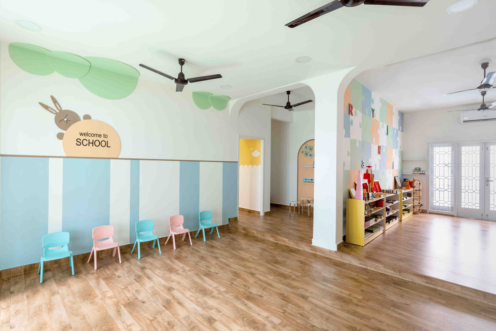 Bright, colorful classroom with wooden flooring and chairs.
