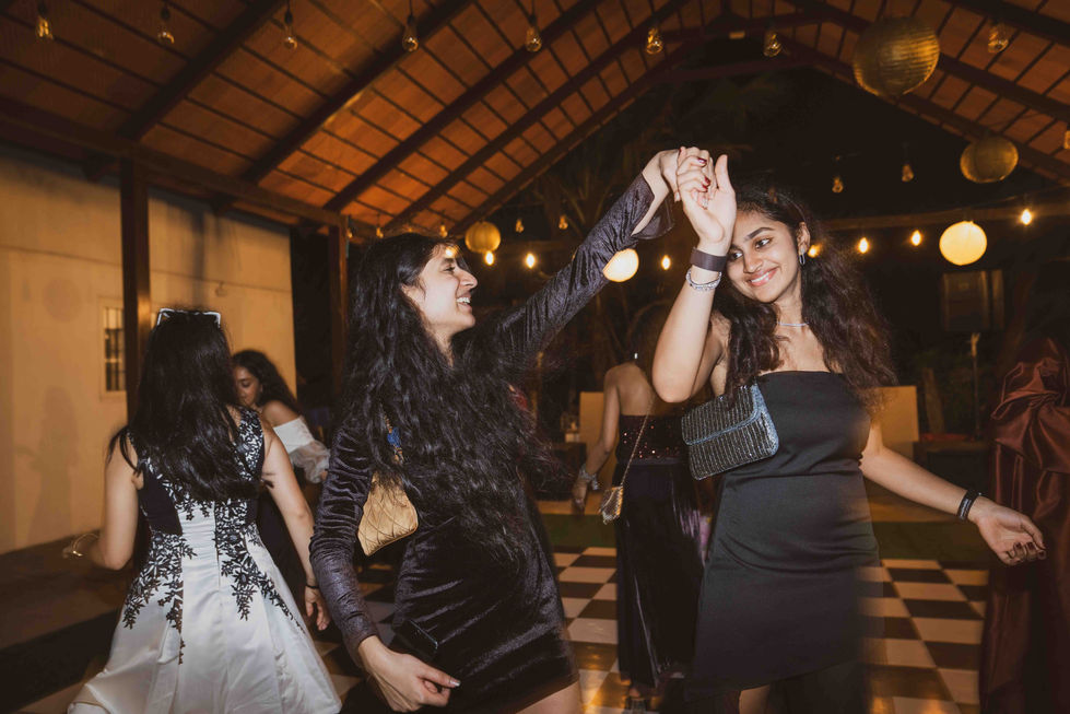 Two people dancing at an indoor event.