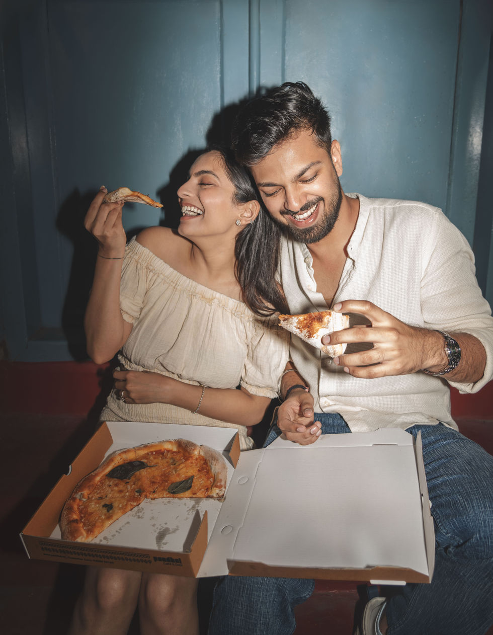 Candid photograph of a couple enjoying a meal together.