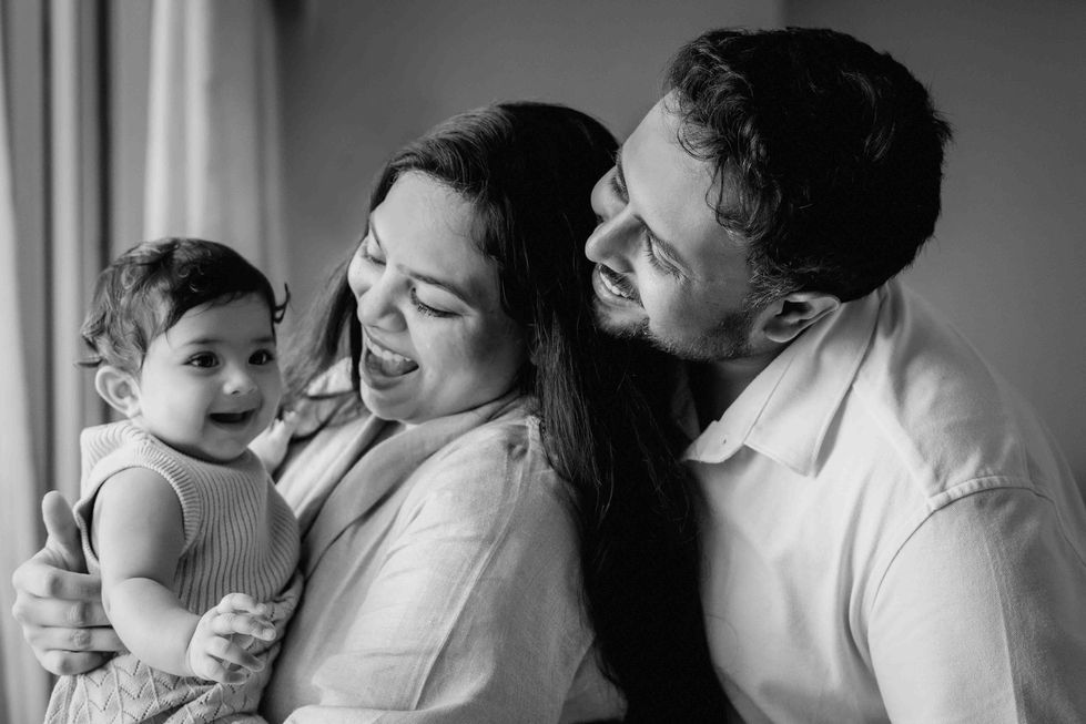 Happy family with a baby, smiling together.