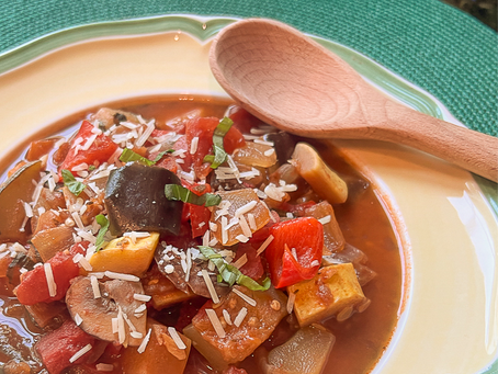 Ratatoulle in a bowl with wooden spoon