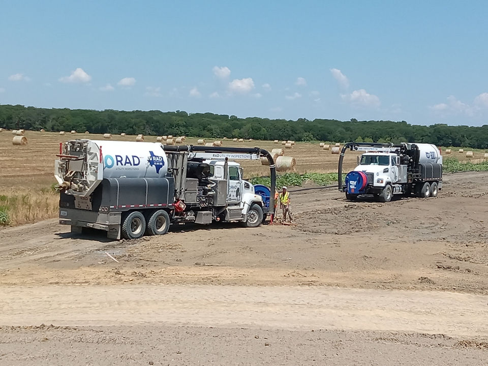 Two RAD Utility Inspections trucks at a job site performing hydro excavation. 