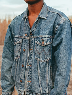 man in blue denim jacket standing on brown field during daytime_edited.jpg