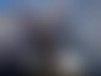 A protester grabs a tear gas grenade deployed by federal immigration officers near the scene where Renee Good was fatally shot by an ICE officer last week, Tuesday, Jan. 13, 2026, in Minneapolis. (AP Photo/John Locher)