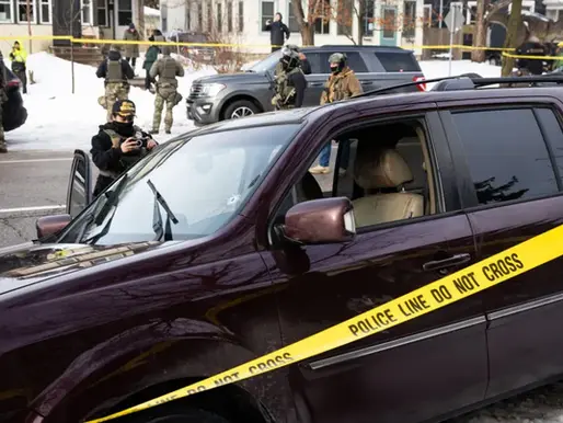 A bullet hole and blood stains are seen in a crashed vehicle on at the scene of a shooting in Minneapolis on Wednesday. (BEN HOVLAND/MINNESOTA PUBLIC RADIO VIA AP)