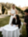 Image of queer couple and officiant at signing table. Couple is signing marriage license. Image Credit --Kelseylageriphotography--