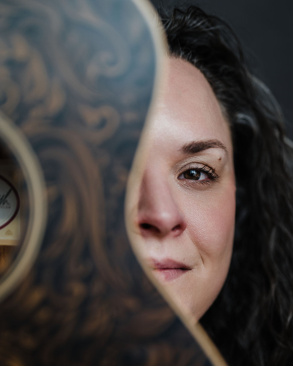 Half of the authors face behind the body of a guitar.