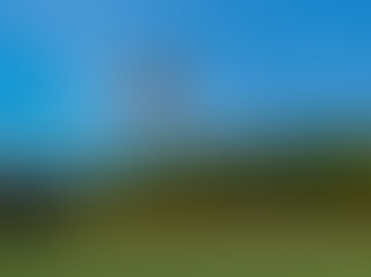 Multicoloured hot air balloon rising into a blue sky