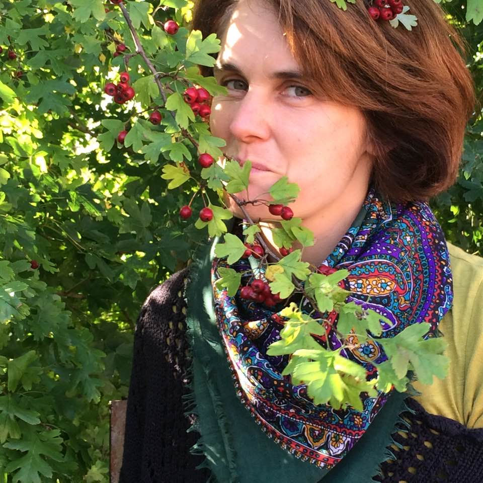 woman eating hawthorn berry off tree