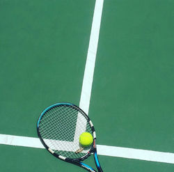 tennis racket and ball on field_edited