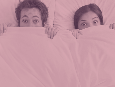 Man and woman under bed sheets