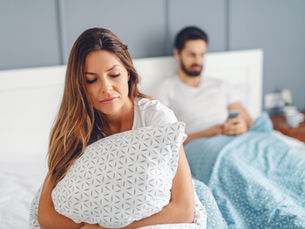 An unhappy spouse in bed