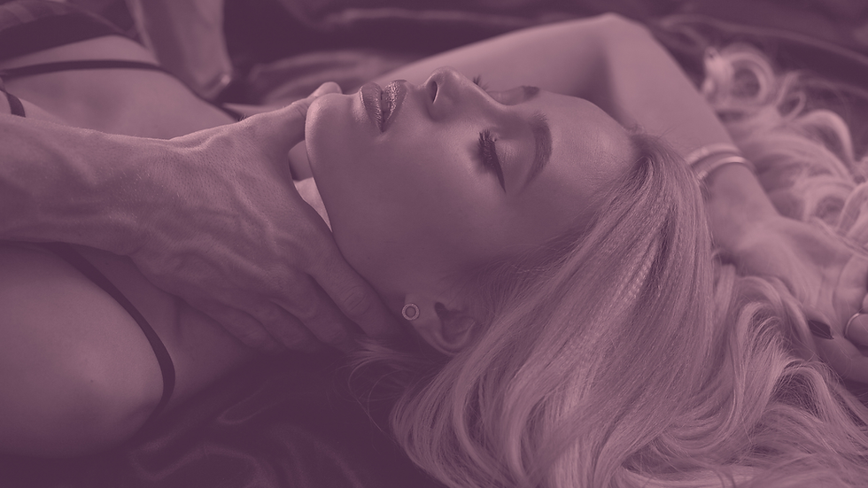A sexy blonde woman laying in bed