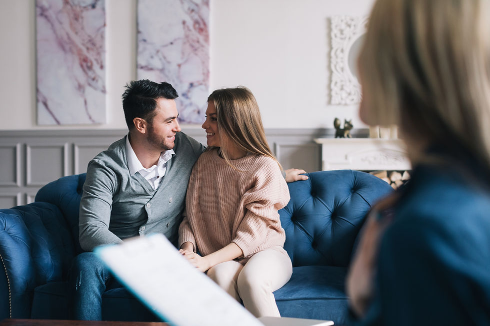 A couple shares a moment of connection and understanding during a sex therapy session.