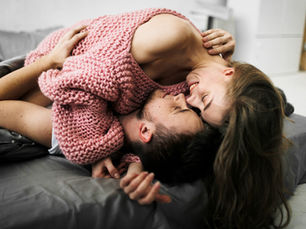 A couple engaging in romantic foreplay