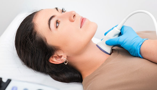 Women undergoing a thyroid ultrasound