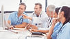 Multidisciplinary team of physicians discussing peripheral artery disease treatment approach
